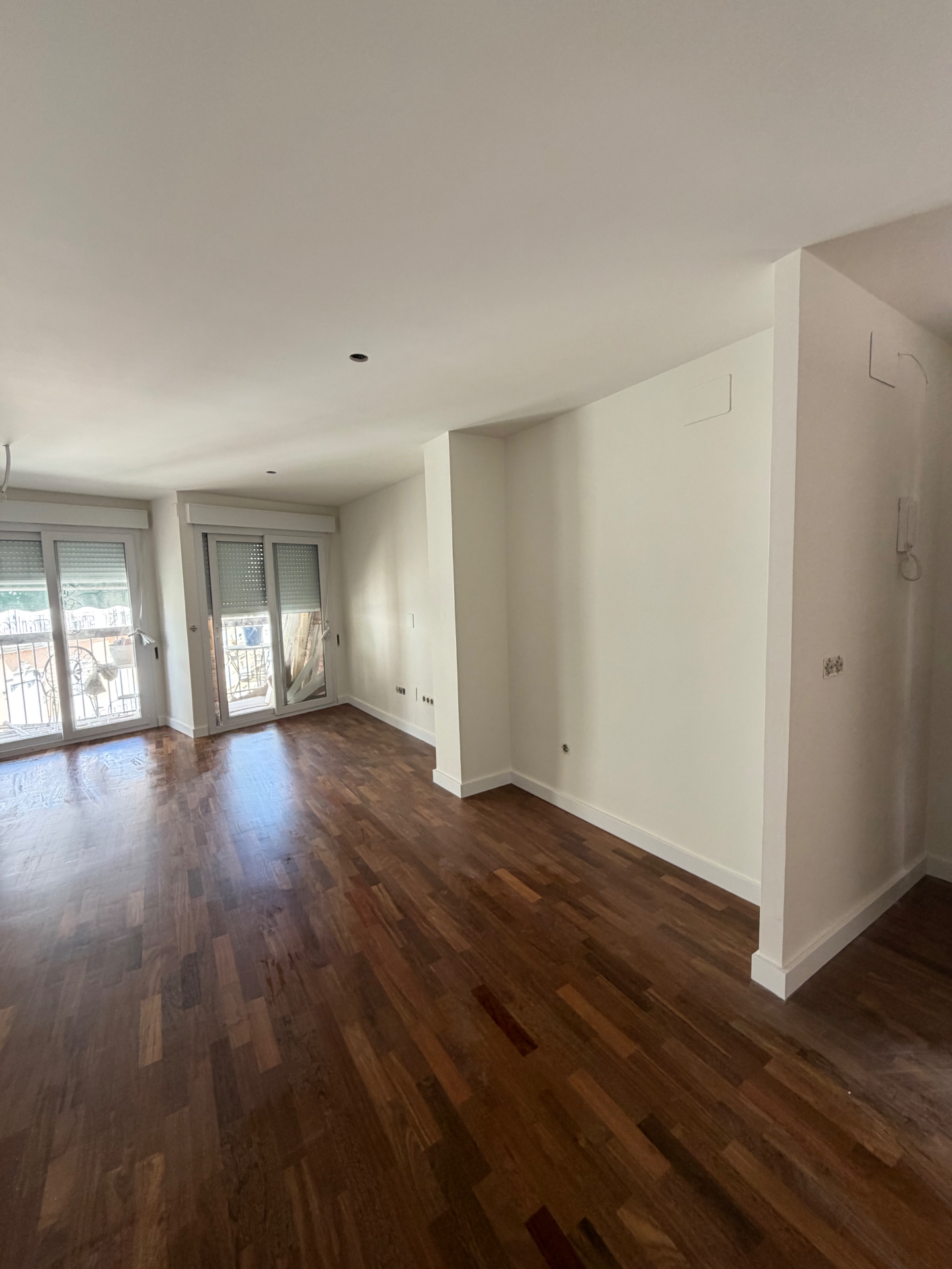Salón en liso fino blanco con tarima de madera
